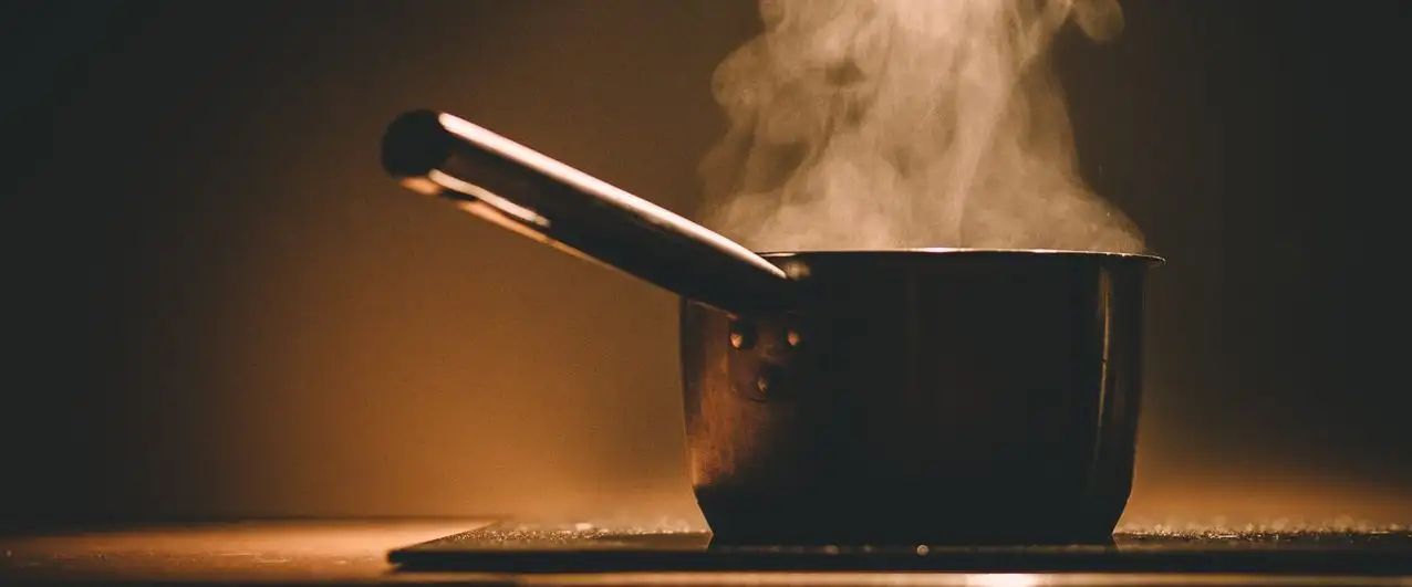 A pot with steam coming out of it from heating